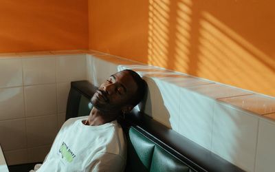 Person resting with closed eyes in a chair