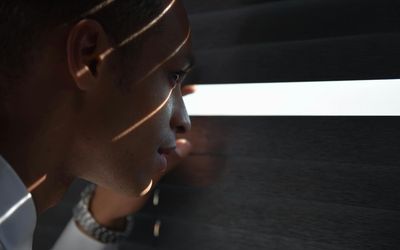 Sunlight streaming through blinds onto a desk